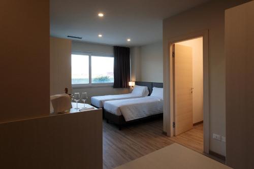 a hotel room with a bed and a window at alla campagna in Trissino