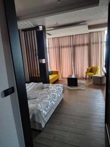 a bedroom with a bed and a living room at Aurora Kopaonik in Raška
