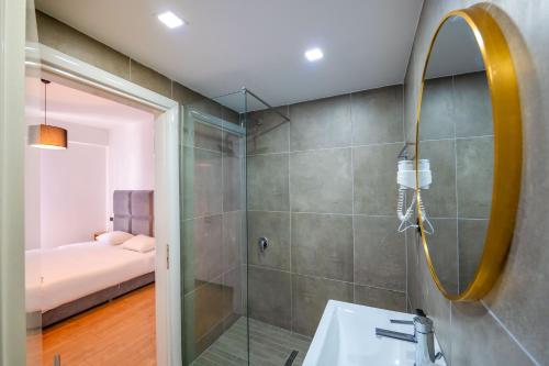 a bathroom with a shower and a sink at Diamond Prestige Hotel in Sarandë