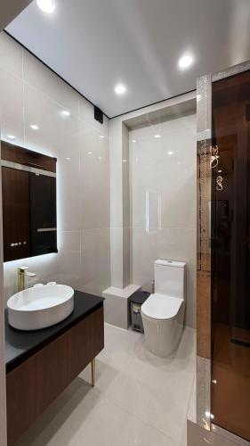 a bathroom with a sink and a toilet at Capital city in Shymkent