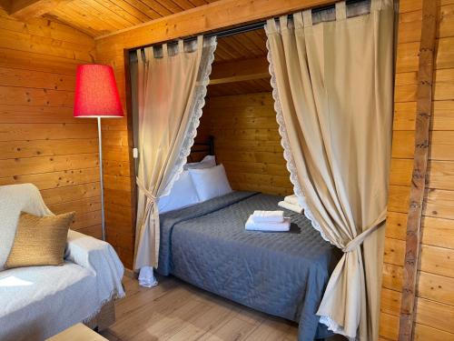 a bedroom with a bed in a log cabin at Wild Life Chalets in Rafína
