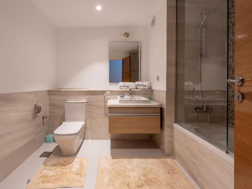 a bathroom with a toilet and a sink and a shower at BirdNest Vacation homes at Marassi marina in El Alamein