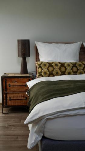 a bedroom with a bed and a lamp on a night stand at Boutique-Hotel "Stilvoll" in Andernach