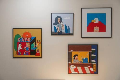 a group of pictures hanging on a wall at Puddings Home Compact Apartment State Library in Melbourne