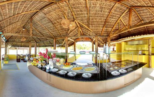 a large kitchen with a buffet in a building at Makaira Beach Resort in Canavieiras