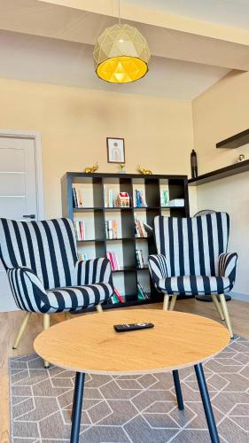 two chairs and a coffee table in a room at Apartment Mira in Ružomberok