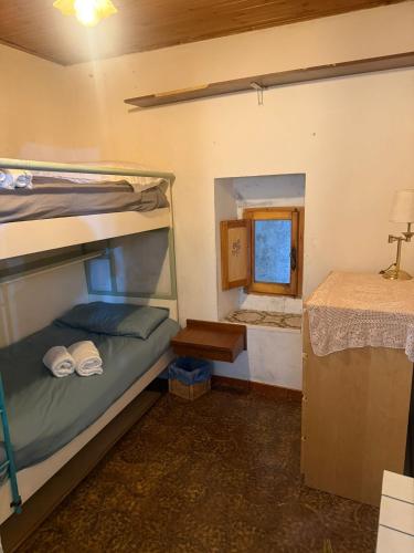 a bedroom with two bunk beds and a desk at La Finestra Sul Paese in Pescocostanzo