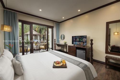 a bedroom with a bed with a tray of food on it at La palm Luang prabang in Luang Prabang