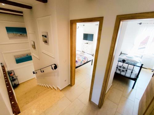 a hallway with a door leading to a bedroom at Holiday House - OLD QUEEN in Šmrika