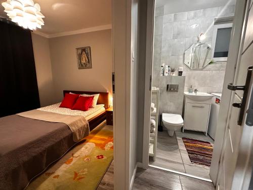 a bedroom with a bed and a bathroom with a sink at InCentrum Pańska 3 in Warsaw