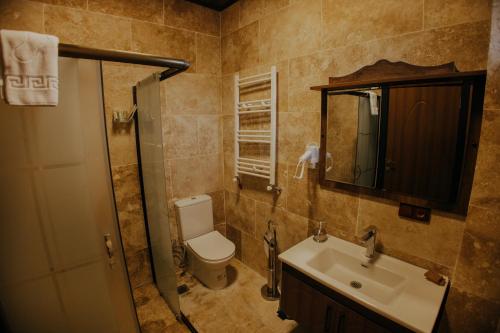 a bathroom with a toilet and a sink at Konak Stone House in Ürgüp