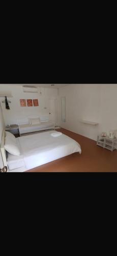 a bedroom with a white bed in a room at Ruma in Cherating