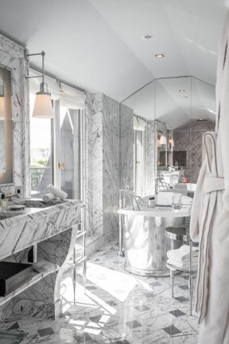 a bathroom with a sink and a mirror at La Réserve Paris Hotel & Spa in Paris