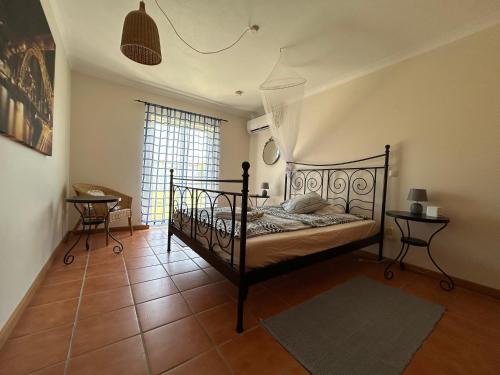 a bedroom with a bed in a room with a window at Poolvilla Casa Sol in Aljezur