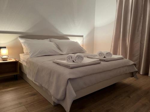 a bedroom with a bed with two towels on it at Apartmani KIKO in Međugorje