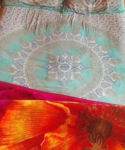 a close up of a quilt with a flower on it at Khan Camping Naranag in Sonāmarg