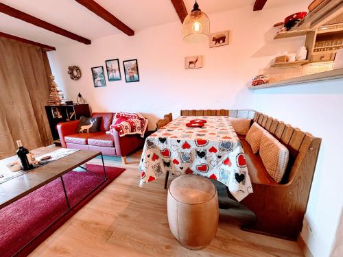 a living room with a table and a couch at LOVErbier with pool in building, steps to Place Central in Verbier