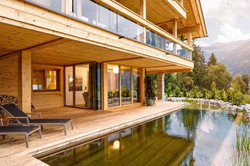 a house with a pool in front of it at RACING Suite - Terrace & Sauna Access in Kleinboden