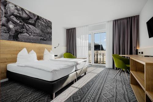 a hotel room with a bed and a desk at Landgasthaus Fischer in Bad Nenndorf