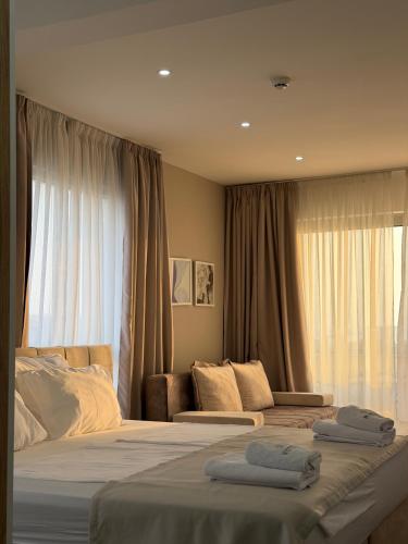 a hotel room with two beds and a window at Lux Hotel M - Boutique Hotel & Restaurant in Dobra Voda