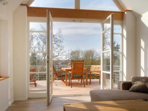a living room with a sliding glass door leading to a patio at Kapitänsdeck in Wustrow