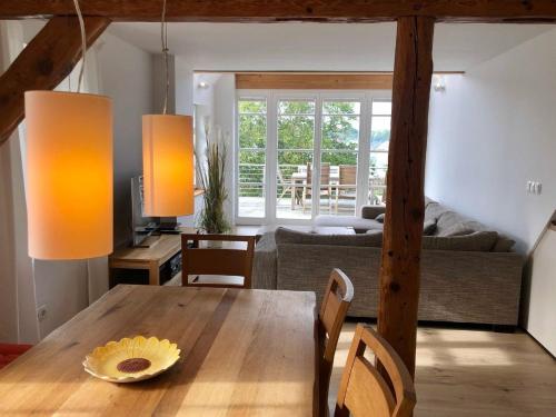 a dining room with a table and a couch at Kapitänsdeck in Wustrow