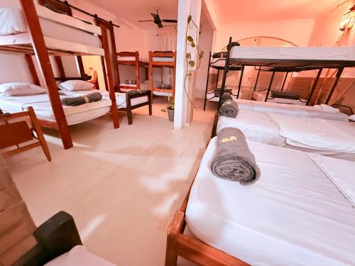 a room with three bunk beds in it at OLO Hostel Boutique & Bar Club SANTA FE in Santa Fe