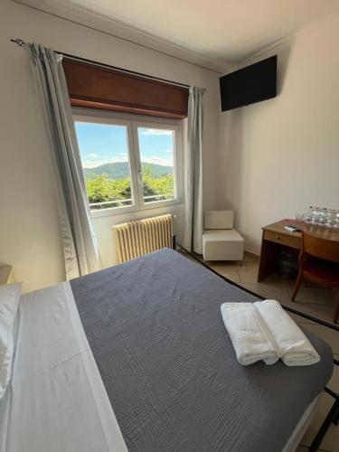 a bedroom with a large bed with a large window at Hotel Ristorante San Michele in Ome