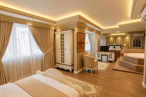 a hotel room with a bed and a bath tub at REAL KiNG RESiDENCE in Trabzon