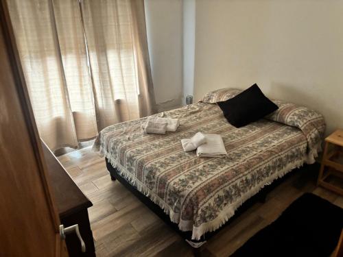 a bedroom with a bed with two towels on it at Alumine in Coronel Suárez
