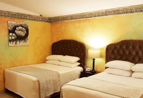 Tempat tidur dalam kamar di Antigua Inn Hotel
