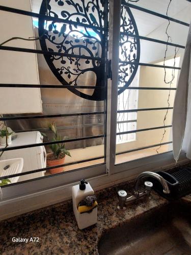 a kitchen sink with a window next to a sink at Departamento Naon SP in San Pedro
