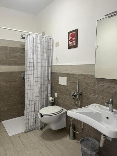 a bathroom with a toilet and a sink at Hotel Ristorante San Michele in Ome