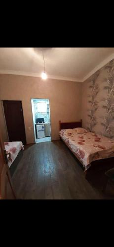 a bedroom with a bed and a kitchen in it at temo lali in Tbilisi City