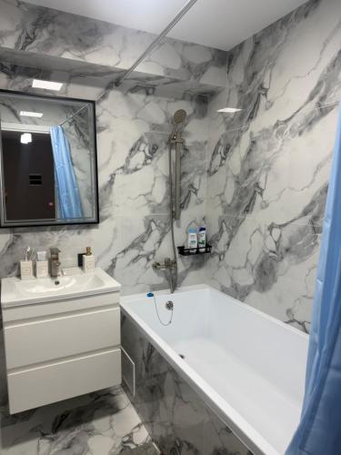 a bathroom with a white sink and a mirror at Kogălniceanu 23 in Căuşeni