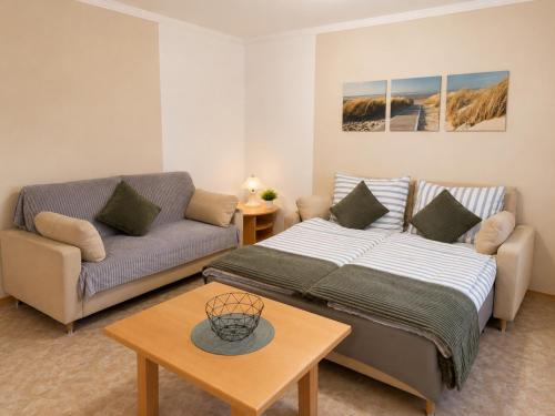 a living room with a bed and a couch at Ferienwohnung am Arberzentrum in Zwiesel