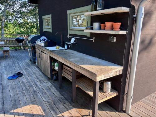 a kitchen on a patio with a counter and a sink at The Archipelago Hideaway in Vaxholm