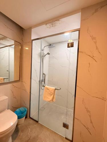 a bathroom with a glass shower with a toilet at Agile Residence By Arshad in Kuala Lumpur