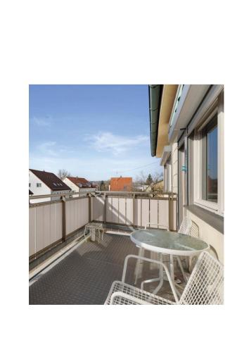 a patio with a table and chairs on a balcony at Residence KESH in Krumbach