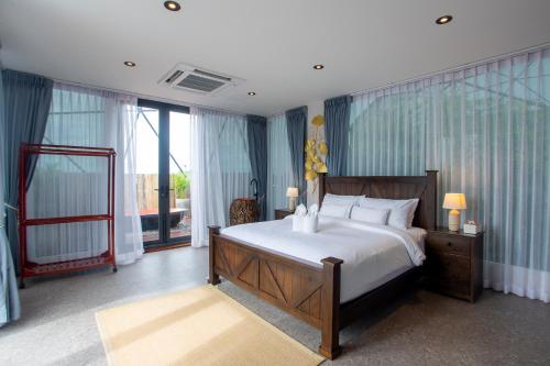 a bedroom with a large bed and a large window at Sawasdee pool villa, Hua Hin in Hua Hin