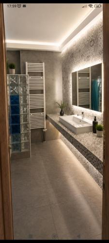 a bathroom with a sink and a mirror at Vasiliki apartment in Kalamata