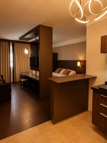 a hotel room with a bed and a desk at Palace Hotel in Itajubá