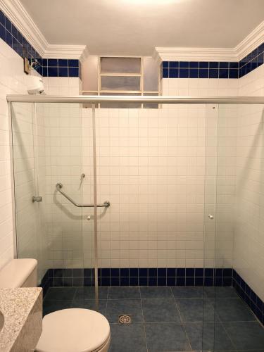 a bathroom with a glass shower with a toilet at Palace Hotel in Itajubá