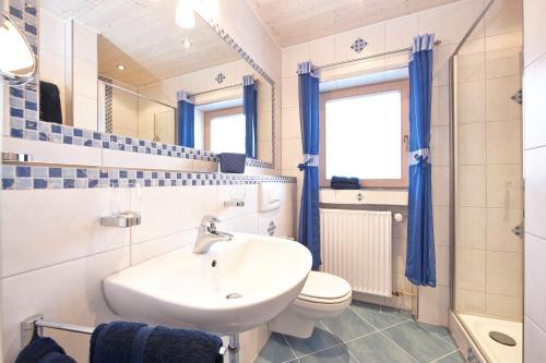 a bathroom with a sink and a toilet at Frickenblick Lounge & Sauna in Farchant