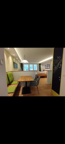 a living room with a wooden table and a couch at FeWo Hirsch in Todtmoos