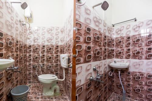 a bathroom with a toilet and a sink at B2N Hotels Near Sri Ramachandra Hospital Porur in Chennai