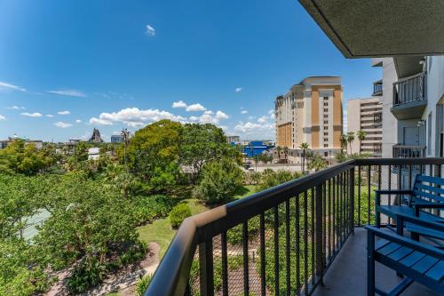 a balcony with benches and a view of a city at Volcano View 2 Bed 2 Bath Condo with Balcony in Orlando