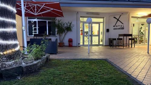 a front porch of a house with an umbrella at X Hotel in Punta Marina