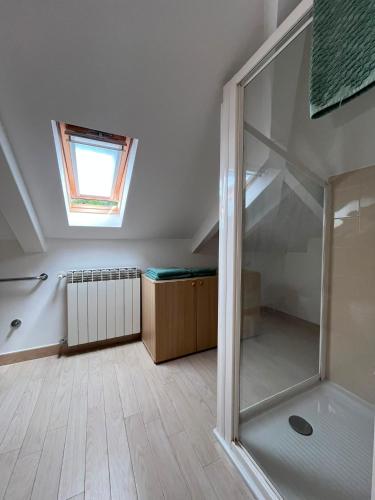 an attic room with a shower and a skylight at Casa Monnalisa - Calandre Sabbie Oro in Ventimiglia