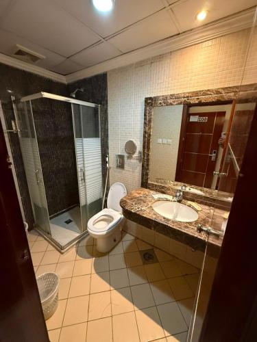 a bathroom with a toilet and a sink and a shower at فندق سما المشاعر اجياد Sama Al Masher Ajyad in Ajyad